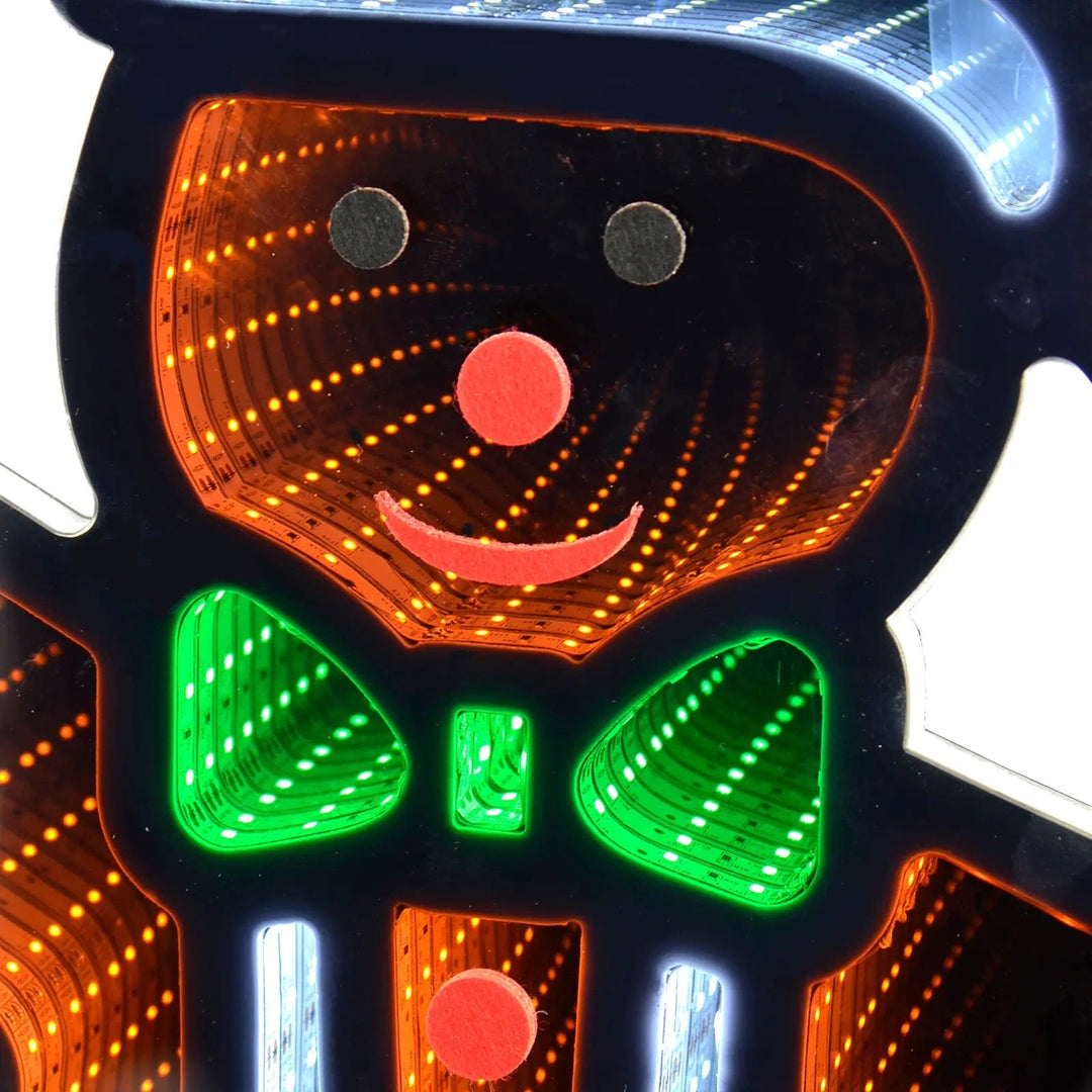 Close up of the face and green bow tie of a gingerbread man infinity mirror Christmas light decoration