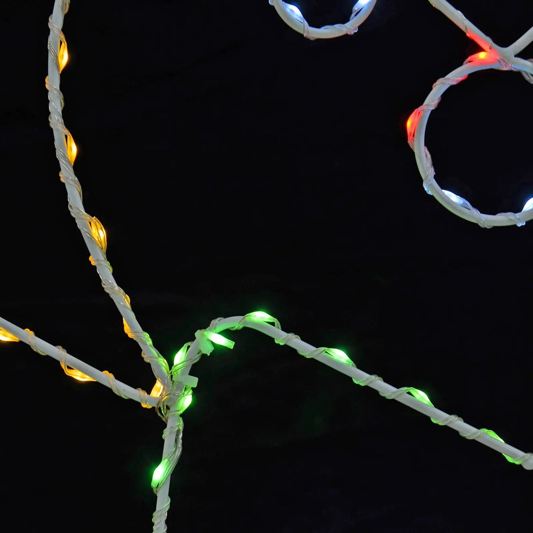 Close up of green, yellow and red LED lights wrapped around a white wire frame Christmas decoration