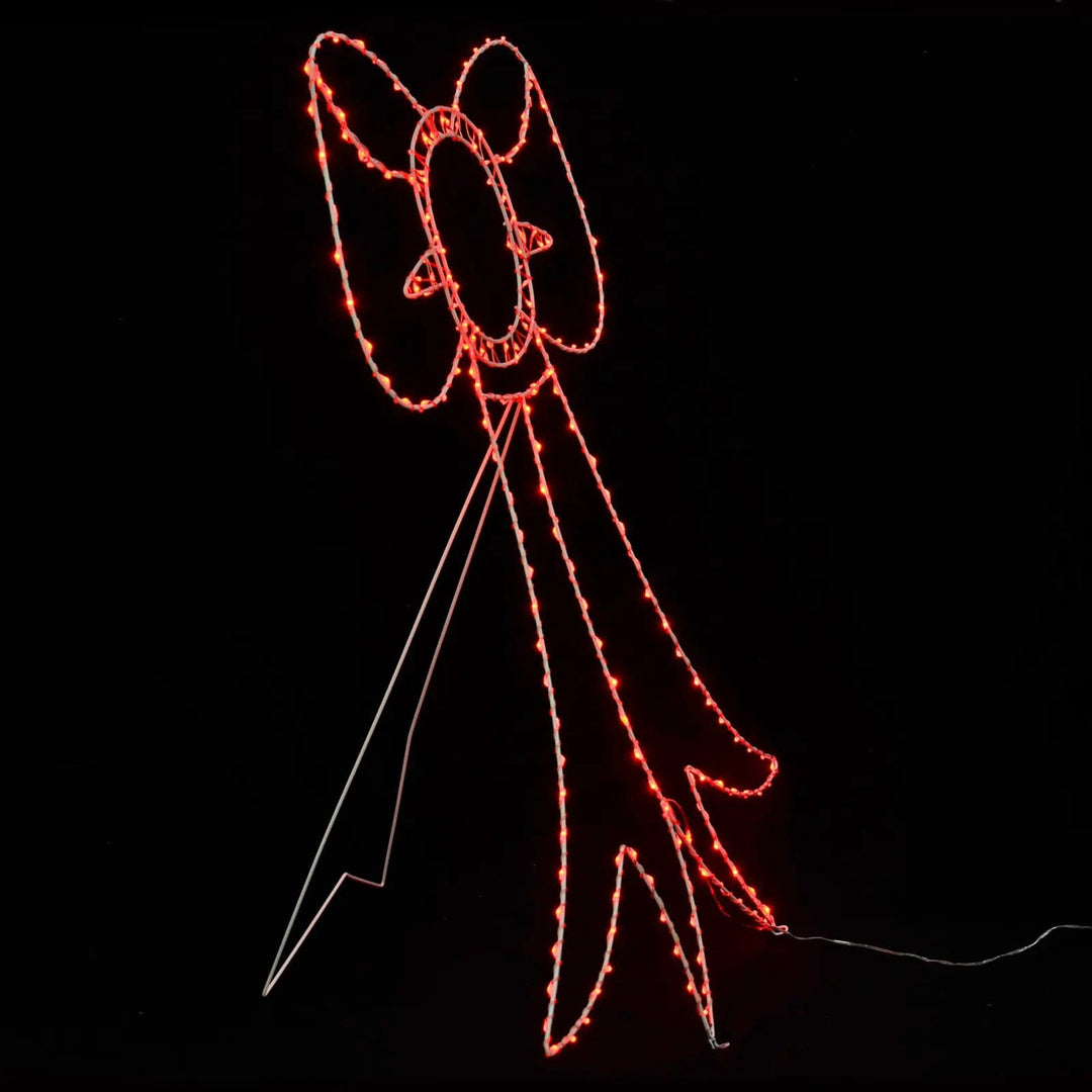 Side view of a red bow Christmas silhouette light with stand