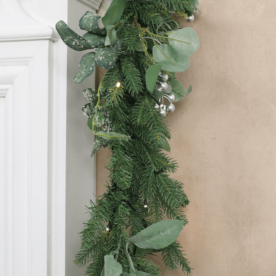 detail shot of garland hanging over fireplace mantel in living room