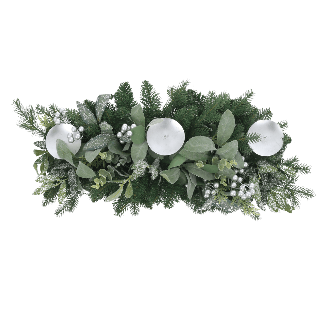 top view of table centrepiece with silver berries and pine branches with 3 candle holders