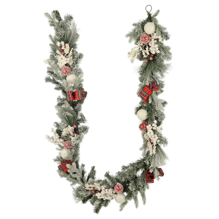 Christmas garland with red tartan ribbons, red and white baubles, frosted  green pine and snowberries