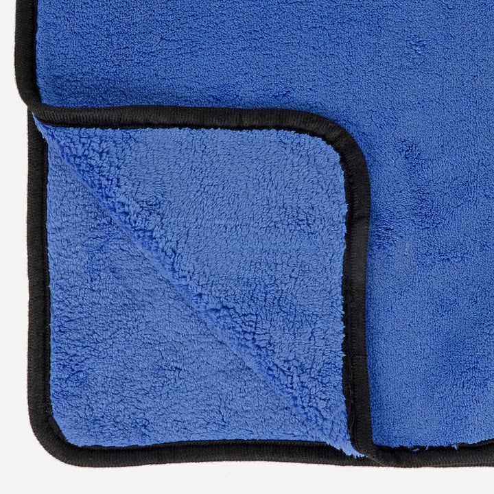 Close up of both sides of a blue microfibre buffing towel with black woven edge