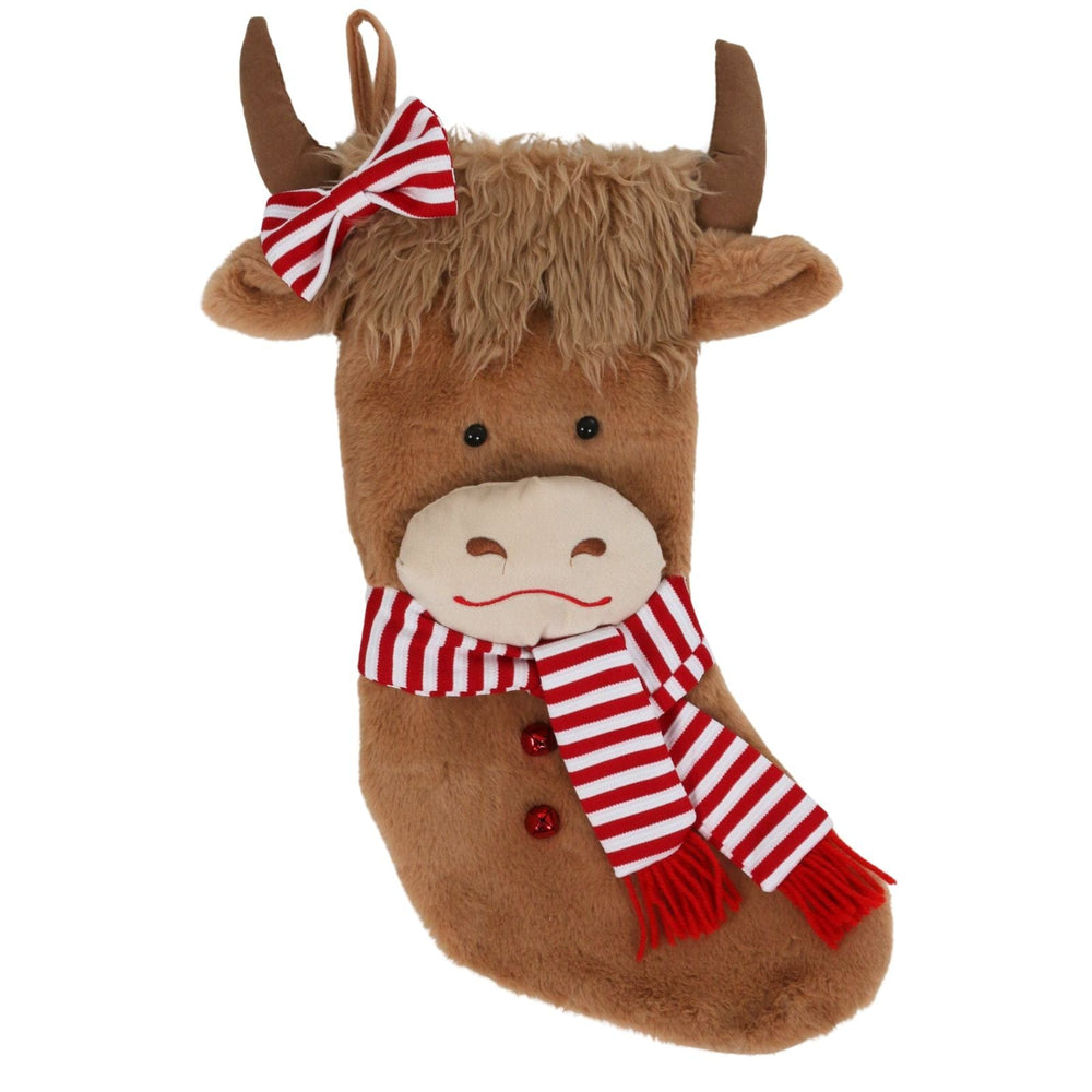 Plush highland cow Christmas stocking with a red and white striped scarf and bow on a white background