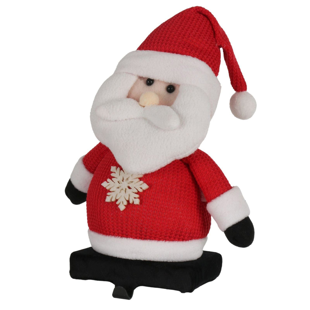 plush santa figure with black metal stocking holder