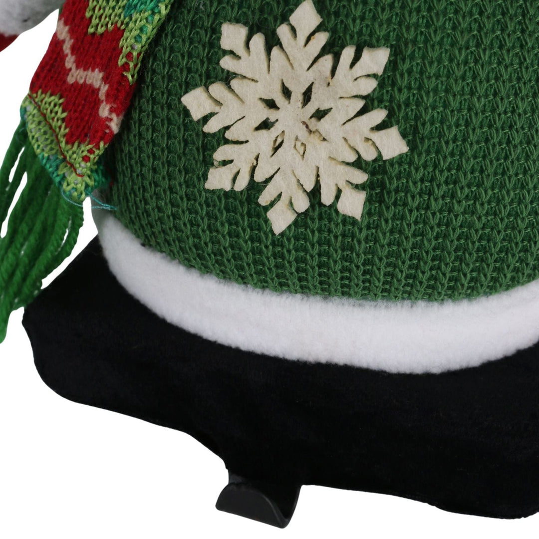 detail shot of snowflake on green waffle material with metal hook to hang stockings