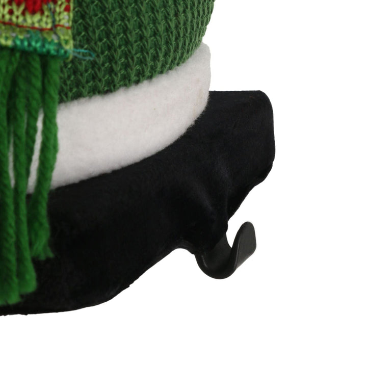 close up of metal hook to hang stocking on green snowman figure