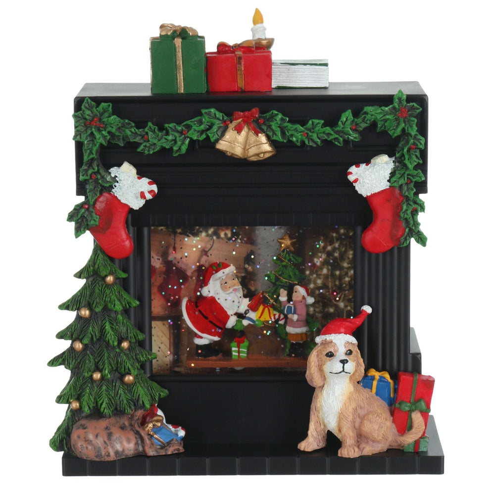 Decorative Christmas scene ornament 
with a fireplace, Santa Claus, dog, and presents on a white background.