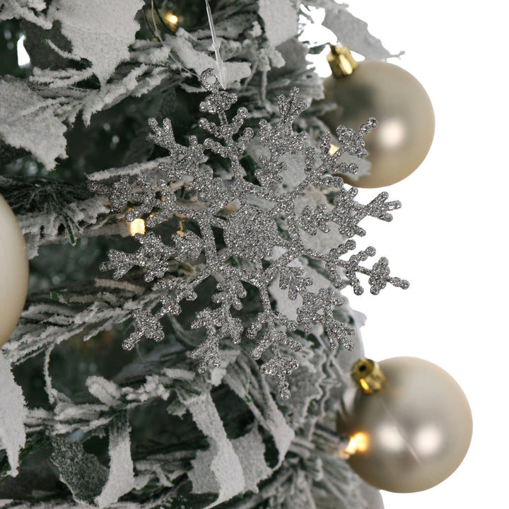 close up of glitter silver snowflake on christmas tree