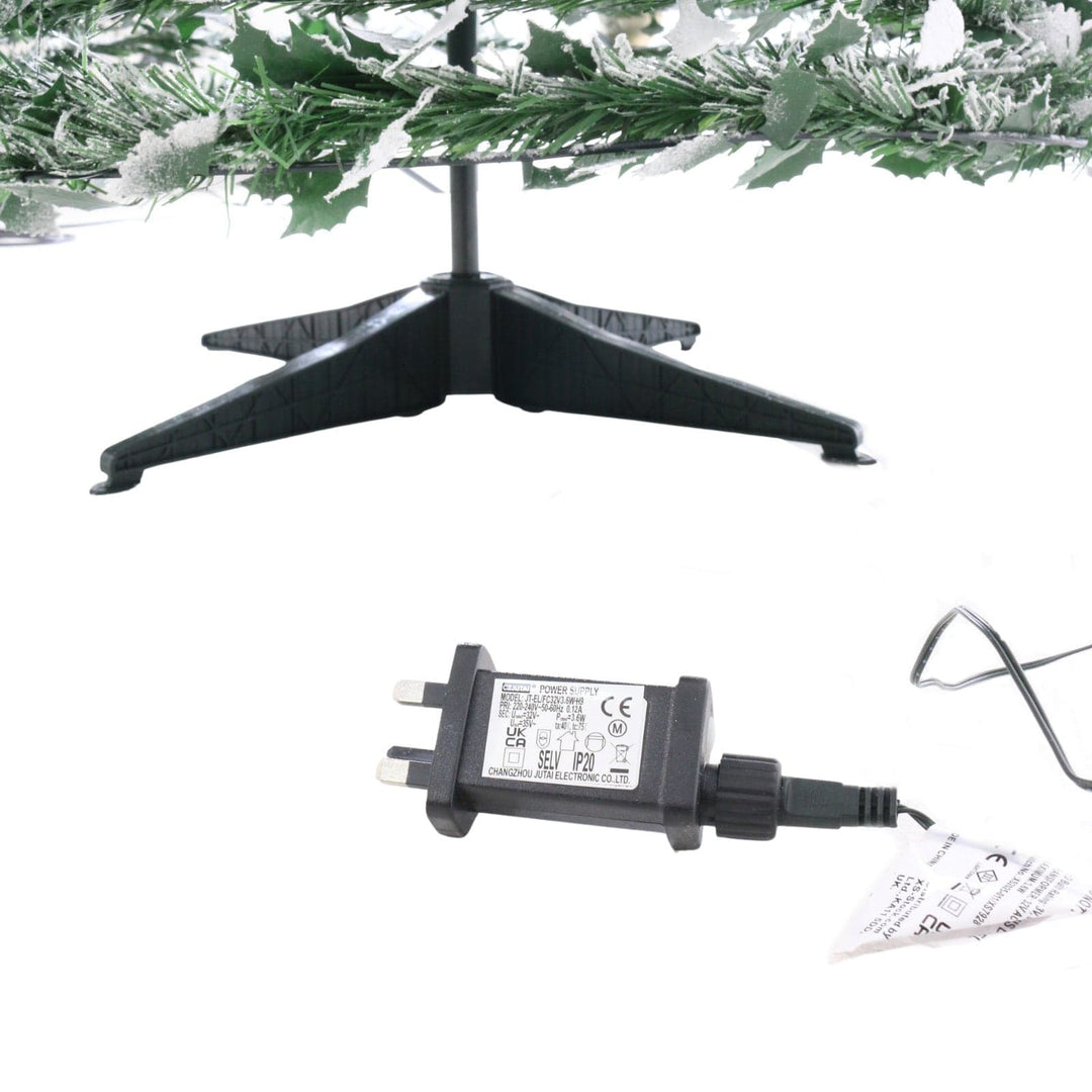 plastic tree stand with transformer on white background