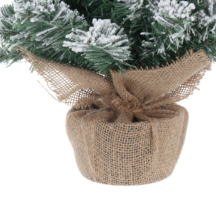 Decorative Christmas tree base wrapped in burlap with a white background