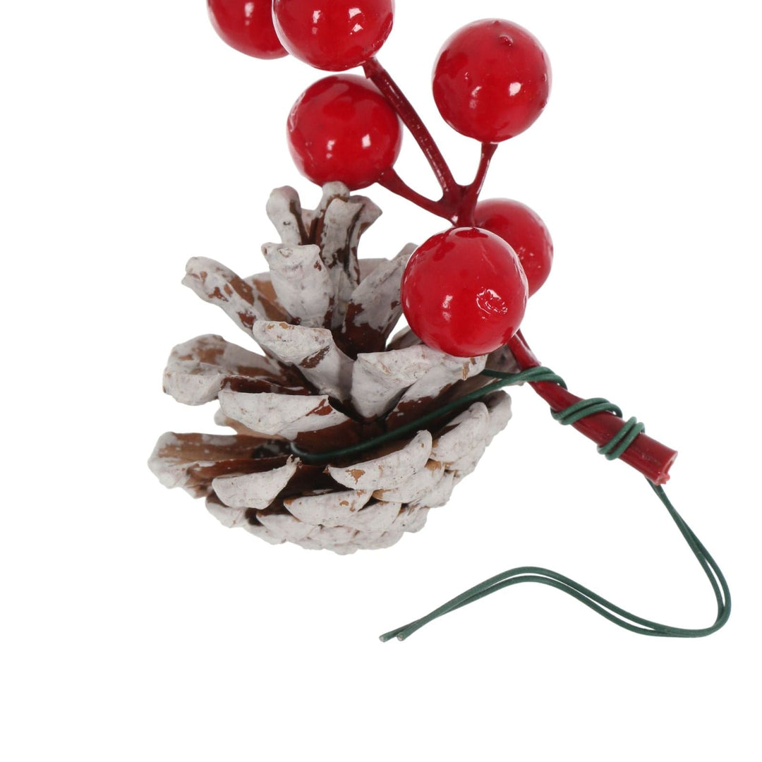 close up of floral wire wrapped around berry and pine cone with extra for securing to tree