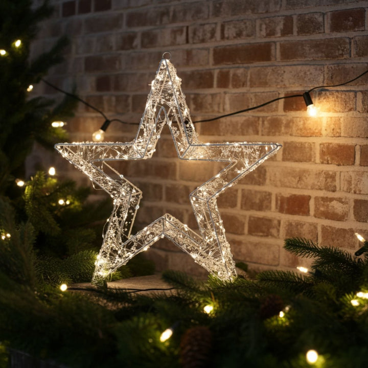 christmas star light on outdoor patio space with christmas garlands and festoon lights in the background