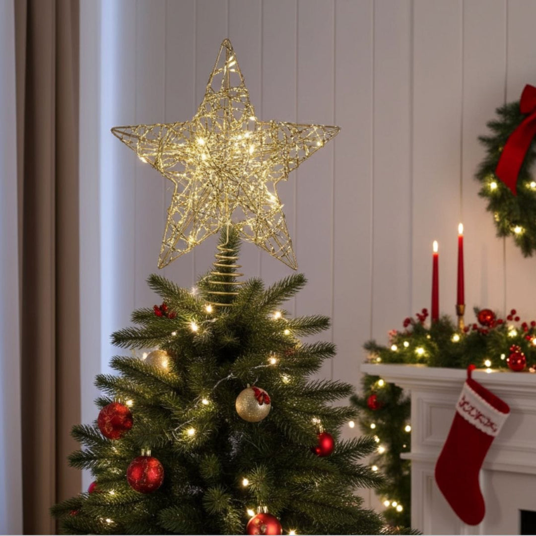 Decorated Christmas tree with a star-shaped light fixture, red ornaments, and a fireplace with stockings.