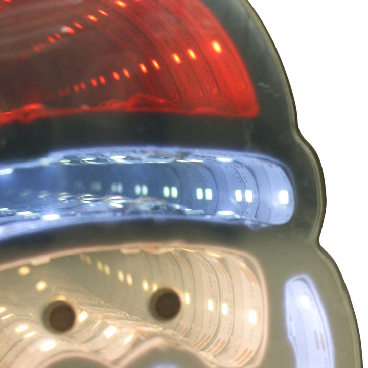 Close-up of a santa face light with red and blue lights.