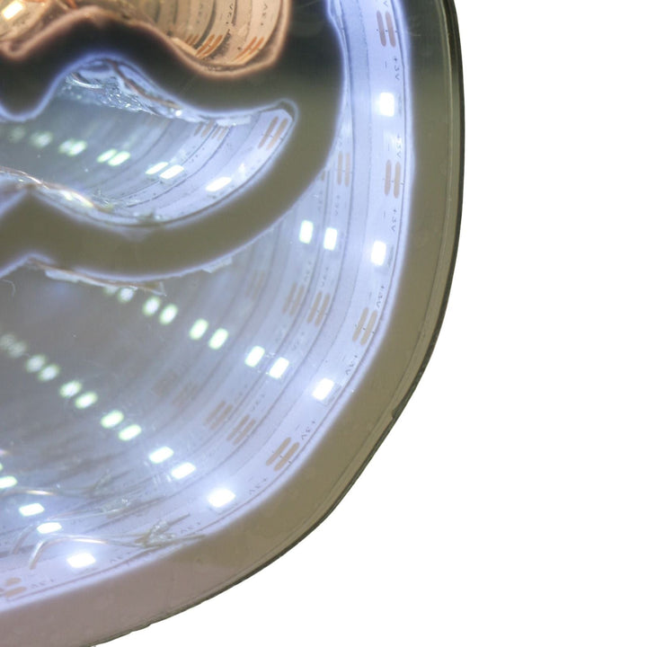 Close-up of LED strip lights inside santa head lamp on a white background