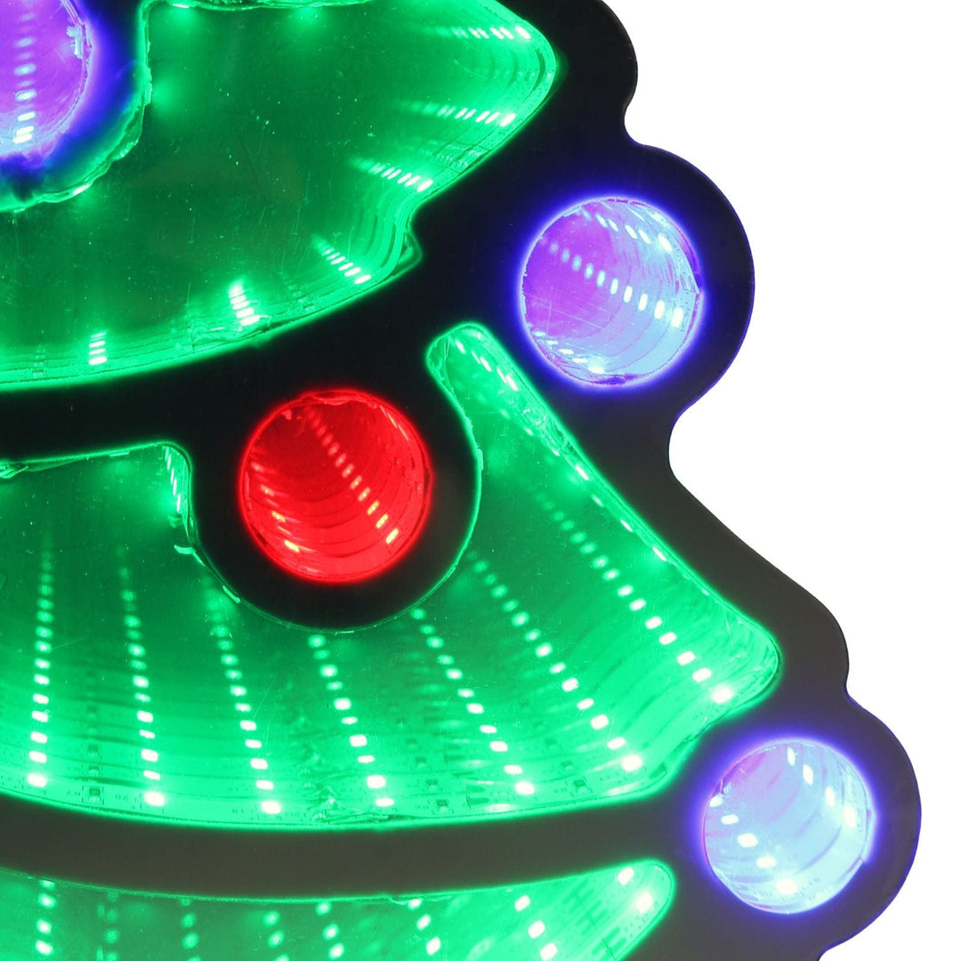 Close-up of a green Christmas tree-shaped light with red and blue lights on a white background
