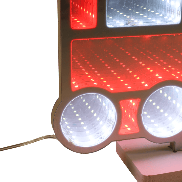 Close-up of train'ss red and white lights on a white background with wire