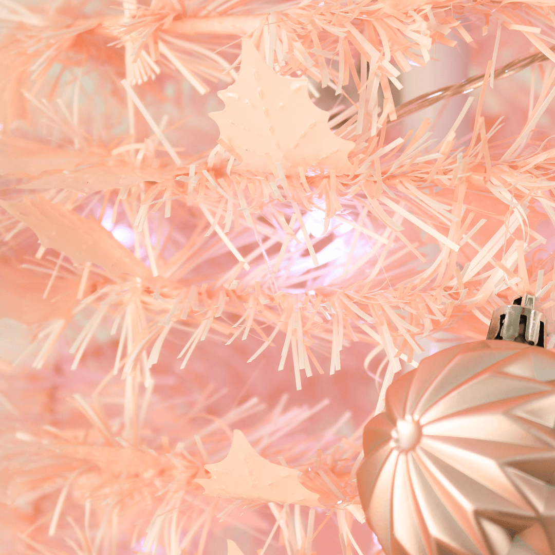 pink tinsel tree with holly shaped tinsel
