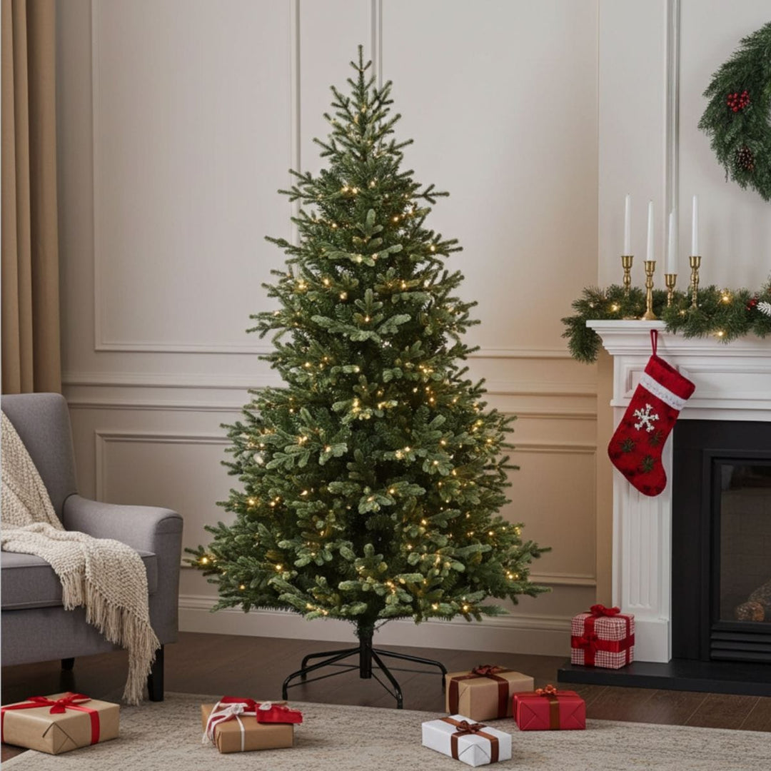 christmas tree in room with fireplace and garland and grey chair covered with blanket