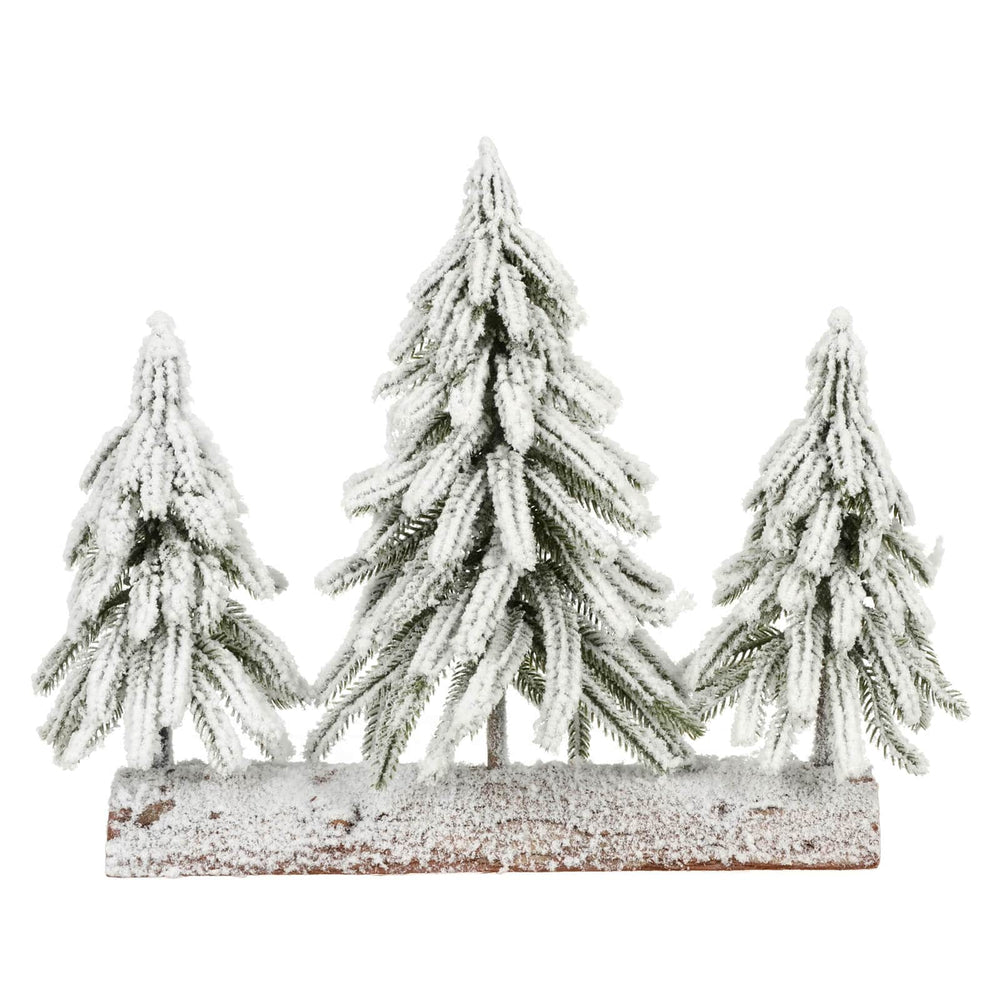Set of three snow-covered pine trees on a wooden base against a white background