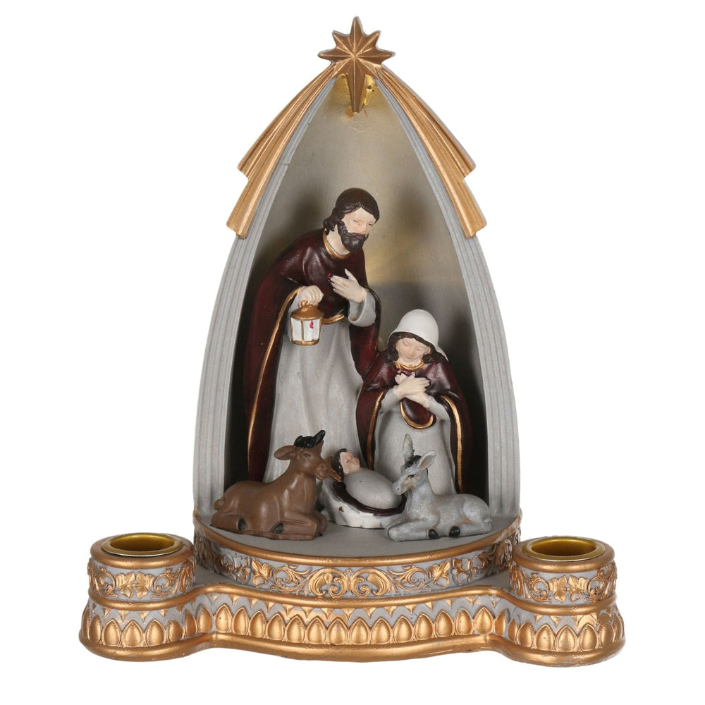 nativity scene ornament featuring mary, joseph, jesus figures with candle holders to the front