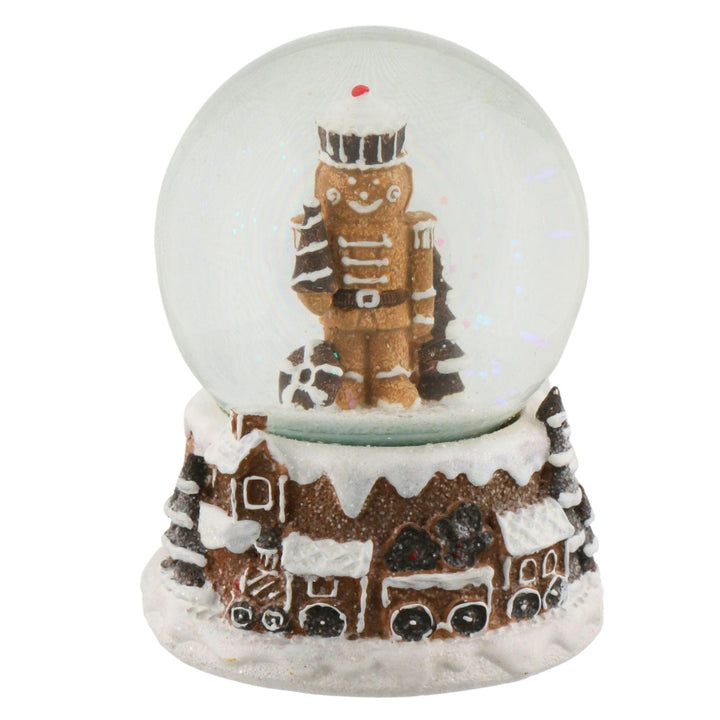 Snow globe with a nutcracker &amp; gingerbread design on a white background