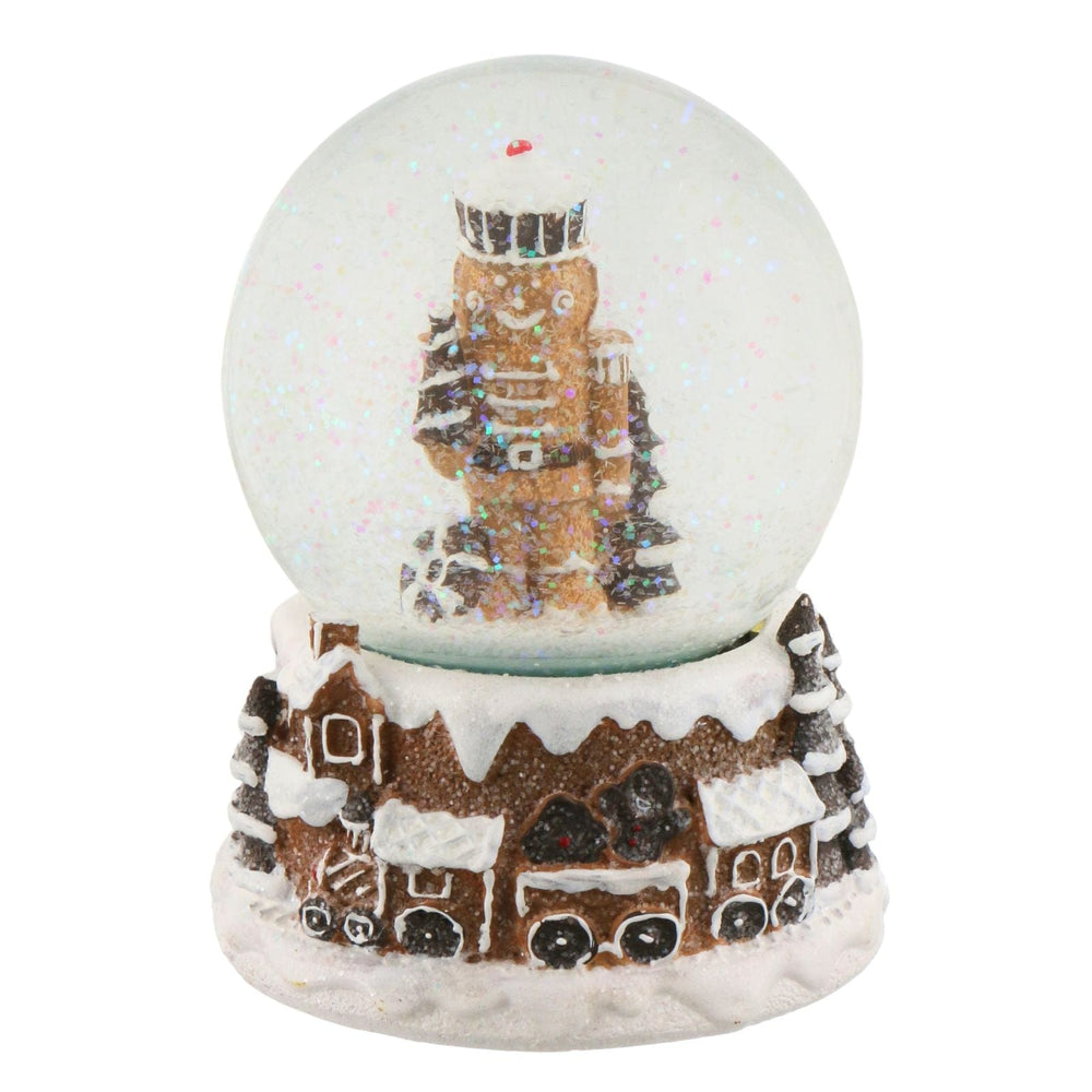 Snow globe with gingerbread house and Nutcracker on a white background