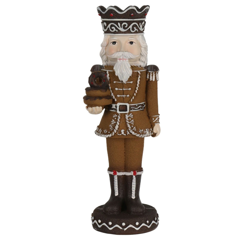 Decorative figurine of a character in a brown outfit with a crown holding doughnuts on a white background