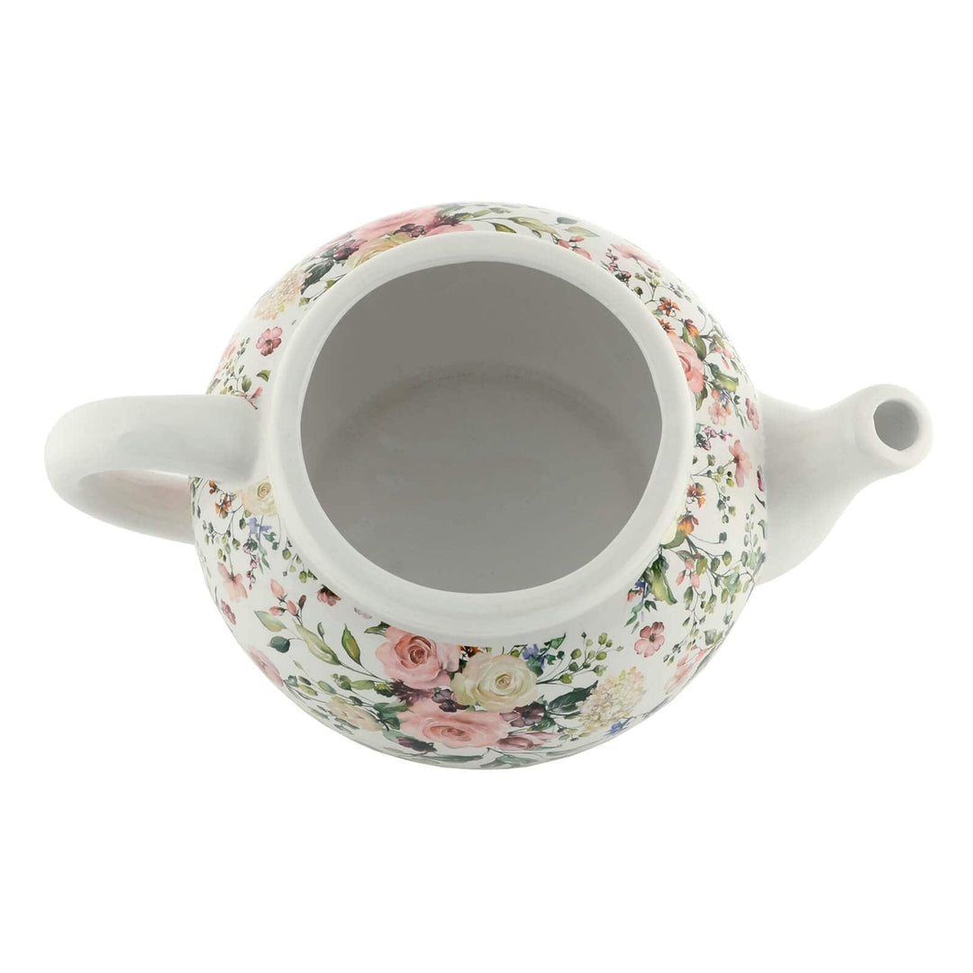 Overhead view of a white ceramic teapot planter with roses pattern