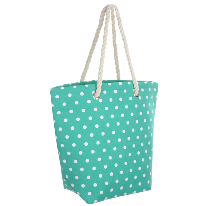 Turquoise green beach bag with white polka dots and rope handles on a white background