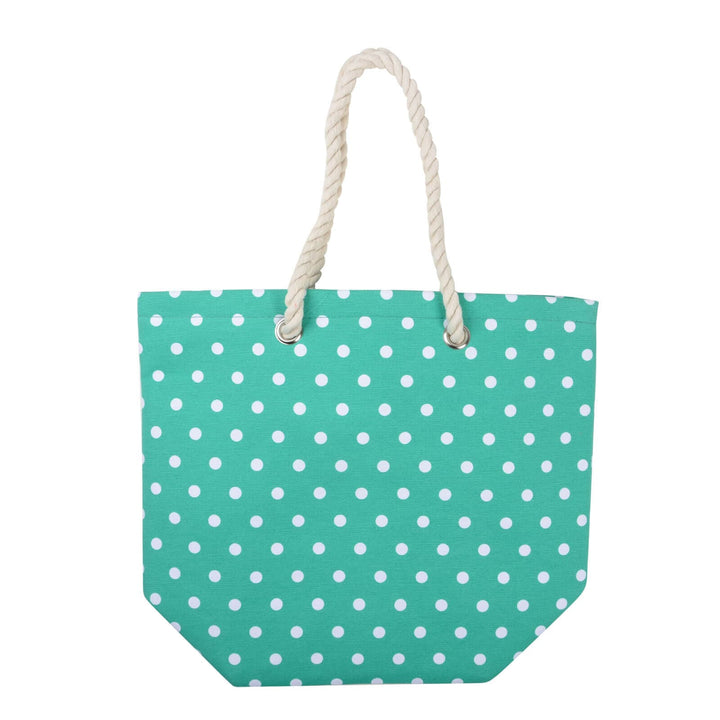 Turquoise green beach bag with white polka dots and rope handles on a white background