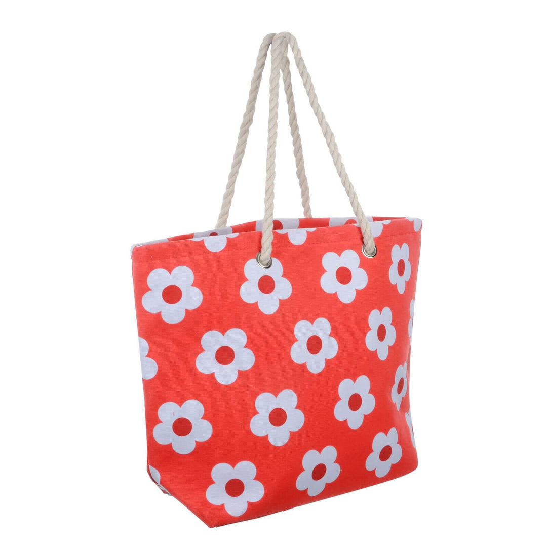 Bright red beach bag with white flowers and rope handles on a white background