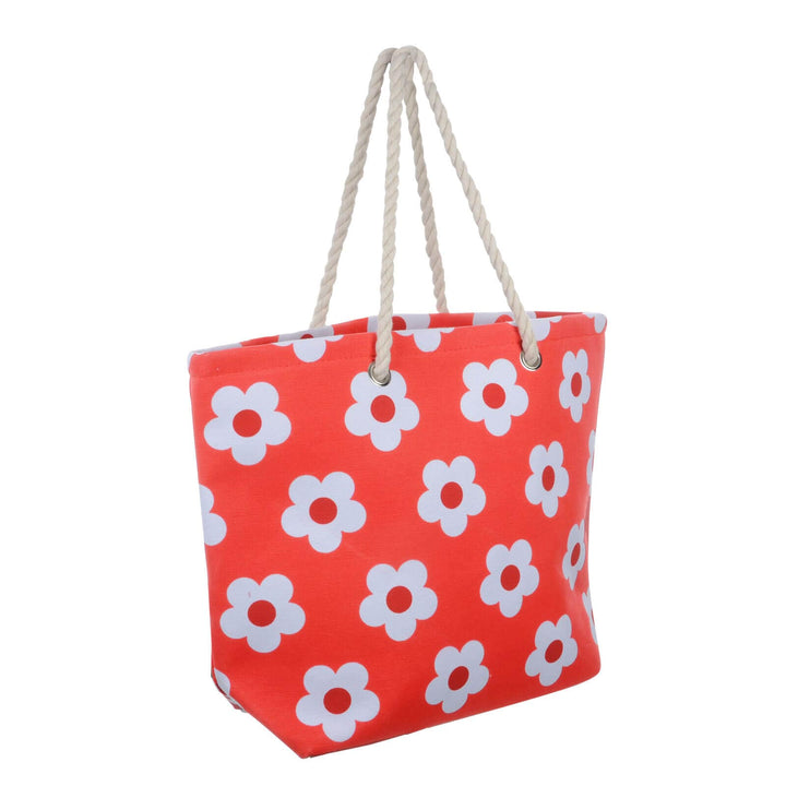 Bright red beach bag with white flowers and rope handles on a white background