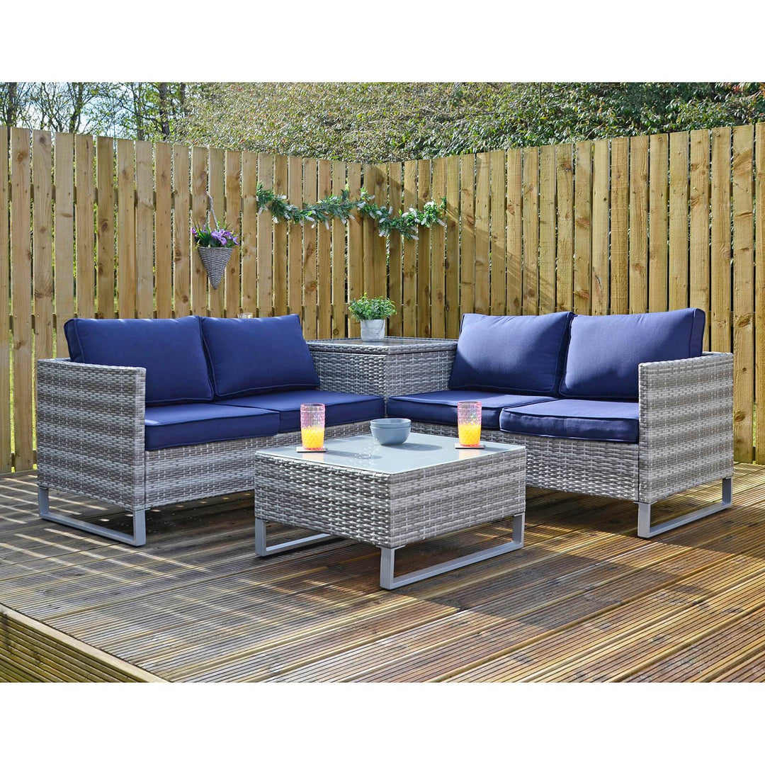grey rattan treviso sofa set on patio space with drinks and snacks on top of glass table top and planter on top of ottoman 