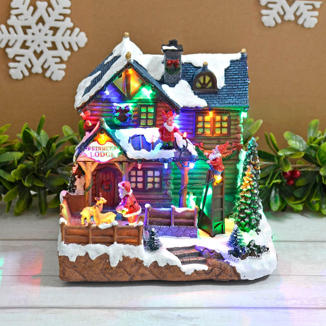 Christmas Reindeer Lodge Snow Scene Light Up Music Moving 24cm