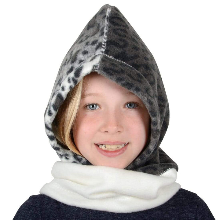 Girl wearing a snow leopard print polar fleece hood on a white background