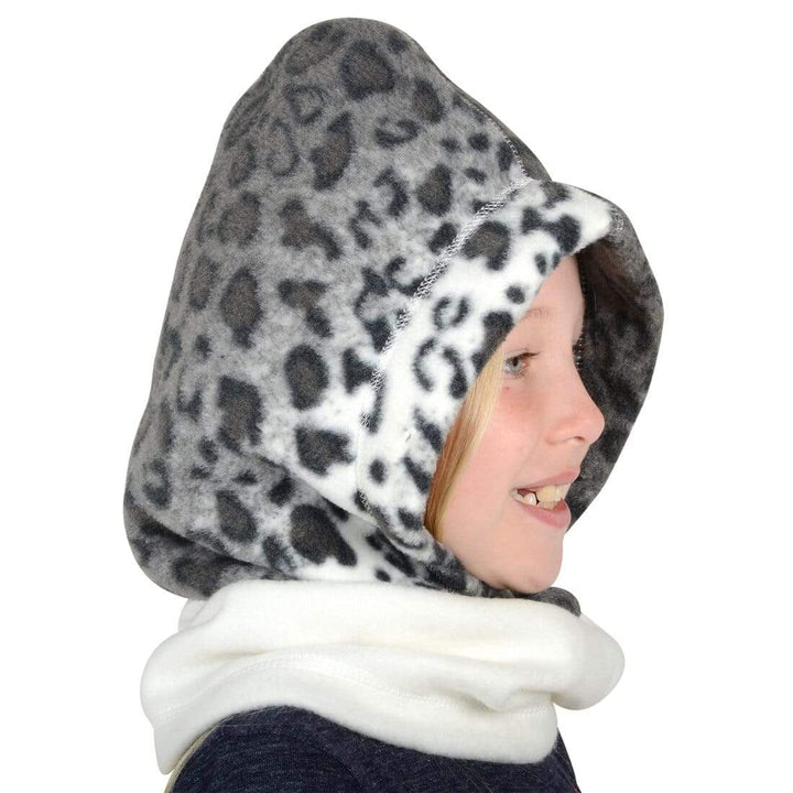 Girl wearing a snow leopard print polar fleece hood on a white background